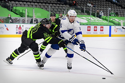 Mar 23, 2021; Dallas, Texas, USA; Dallas Stars defenseman Esa Lindell (23) and Tampa Bay Lightning defenseman Andreas Borgman (5) chase the puck during the first period at the American Airlines Center. Mandatory Credit: Jerome Miron-USA TODAY Sports