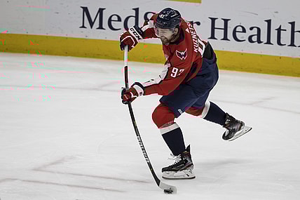 Mar 25, 2021; Washington, District of Columbia, USA; Washington Capitals center Evgeny Kuznetsov (92) shoots the puck against the New Jersey Devils during the third period at Capital One Arena. Mandatory Credit: Scott Taetsch-USA TODAY Sports