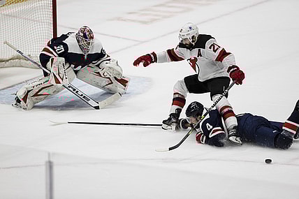 Mar 26, 2021; Washington, District of Columbia, USA; Washington Capitals defenseman Brenden Dillon (4) dives to knock the puck away from New Jersey Devils right wing Kyle Palmieri (21) in front of goaltender Ilya Samsonov (30) during the second period at Capital One Arena. Mandatory Credit: Scott Taetsch-USA TODAY Sports