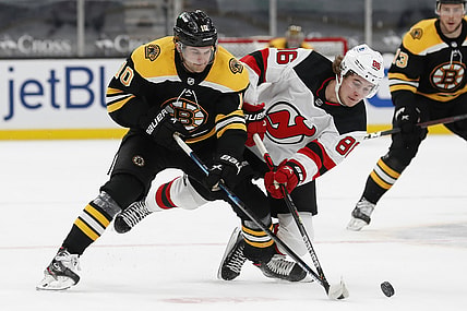 Mar 28, 2021; Boston, Massachusetts, USA; Boston Bruins left wing Anders Bjork (10) battles New Jersey Devils center Jack Hughes (86) for the puck during the first period at TD Garden. Mandatory Credit: Winslow Townson-USA TODAY Sports