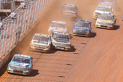Mar 29, 2021; Bristol, TN, USA; NASCAR Gander RV and Outdoors Truck Series driver Martin Truex Jr. (51) leads a pack of cars at Bristol Motor Speedway. Mandatory Credit: Randy Sartin-USA TODAY Sports