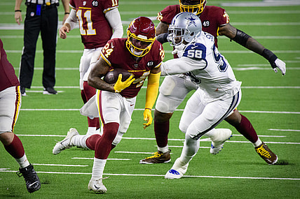 Nov 26, 2020; Arlington, Texas, USA; Washington Football Team running back Antonio Gibson (24) and Dallas Cowboys defensive end Aldon Smith (58) in action during the game between the Dallas Cowboys and the Washington Football Team at AT&T Stadium. Mandatory Credit: Jerome Miron-USA TODAY Sports