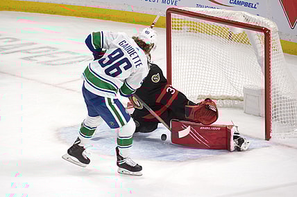 Mar 17, 2021; Ottawa, Ontario, CAN; Vancouver Canucks center Adam Gaudette (96) scores on Ottawa Senators goalie Filip Gustavsson (30) in a shootout at the Canadian Tire Centre. Mandatory Credit: Marc DesRosiers-USA TODAY Sports
