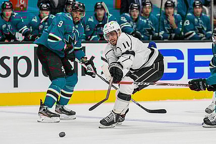 Mar 24, 2021; San Jose, California, USA;  Los Angeles Kings center Anze Kopitar (11) reaches for the puck during the first period against the San Jose Sharks at SAP Center at San Jose. Mandatory Credit: Stan Szeto-USA TODAY Sports