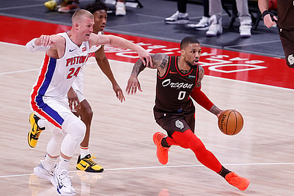Mar 31, 2021; Detroit, Michigan, USA;  Portland Trail Blazers guard Damian Lillard (0) dribbles on Detroit Pistons center Mason Plumlee (24) in the second half at Little Caesars Arena. Mandatory Credit: Rick Osentoski-USA TODAY Sports