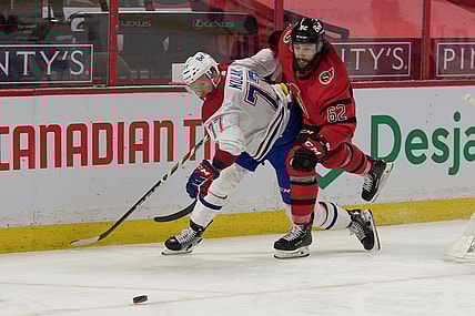 Apr 1, 2021; Ottawa, Ontario, CAN; Montreal Canadiens defenseman Brett Kulak (77) battles with Ottawa Senators center Clark Bishop (62) in the second period at the Canadian Tire Centre. Mandatory Credit: Marc DesRosiers-USA TODAY Sports