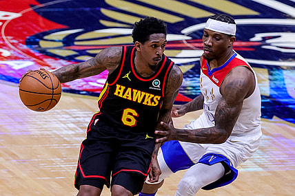 Apr 2, 2021; New Orleans, Louisiana, USA;  Atlanta Hawks guard Lou Williams (6) dribbles around New Orleans Pelicans guard Eric Bledsoe (5) during the first half at the Smoothie King Center. Mandatory Credit: Stephen Lew-USA TODAY Sports
