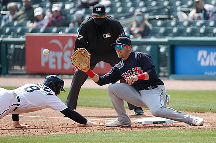Apr 3, 2021; Detroit, Michigan, USA;  Detroit Tigers left fielder Robbie Grossman (8) dives back safe at first before the throw to Cleveland Indians  Jake Bauers (10) first baseman at Comerica Park. Mandatory Credit: Rick Osentoski-USA TODAY Sports