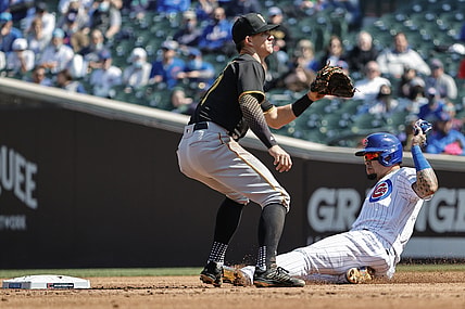 Apr 3, 2021; Chicago, Illinois, USA; Chicago Cubs shortstop Javier Baez (9) steals the second base as Pittsburgh Pirates shortstop Kevin Newman (27) waits for the ball in the second inning at Wrigley Field. Mandatory Credit: Kamil Krzaczynski-USA TODAY Sports