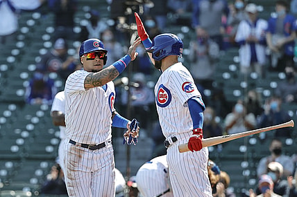 Apr 3, 2021; Chicago, Illinois, USA; Chicago Cubs shortstop Javier Baez (9) celebrates with second baseman David Bote (13) after scoring against the Pittsburgh Pirates in the second inning at Wrigley Field. Mandatory Credit: Kamil Krzaczynski-USA TODAY Sports