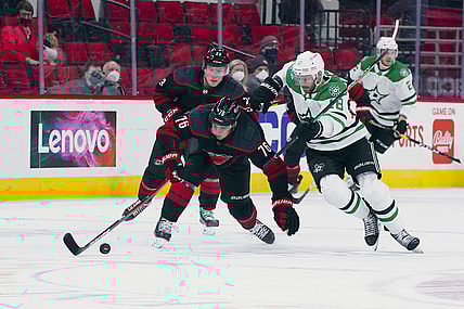 Apr 3, 2021; Raleigh, North Carolina, USA;  Carolina Hurricanes defenseman Brady Skjei (76) and Dallas Stars center Jason Dickinson (18) battle over the puck during the first period at PNC Arena. Mandatory Credit: James Guillory-USA TODAY Sports