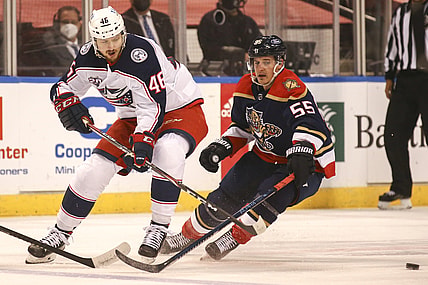 Apr 3, 2021; Sunrise, Florida, USA; Columbus Blue Jackets defenseman Dean Kukan (46) skates with the puck around Florida Panthers center Noel Acciari (55) during the first period at BB&T Center. Mandatory Credit: Sam Navarro-USA TODAY Sports