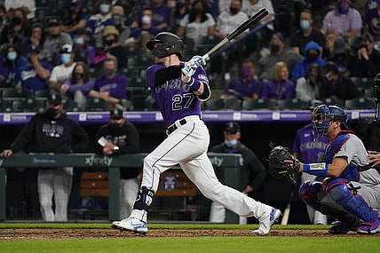 Apr 3, 2021; Denver, Colorado, USA; Colorado Rockies shortstop Trevor Story (27) hits a RBI double against the Los Angeles Dodgers in the eighth inning at Coors Field. Mandatory Credit: Ron Chenoy-USA TODAY Sports