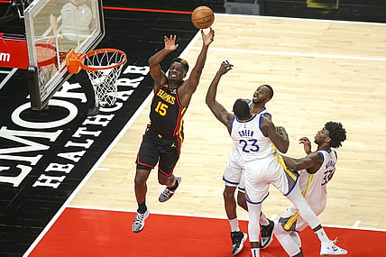 Apr 4, 2021; Atlanta, Georgia, USA; Atlanta Hawks center Clint Capela (15) goes up for an alley oop in front of Golden State Warriors forward Andrew Wiggins (22) and forward Draymond Green (23) and center James Wiseman (33) in the first quarter at State Farm Arena. Mandatory Credit: Brett Davis-USA TODAY Sports