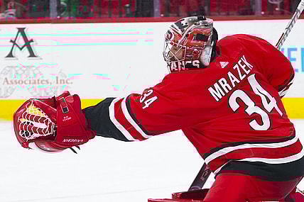 Apr 4, 2021; Raleigh, North Carolina, USA;  Carolina Hurricanes goaltender Petr Mrazek (34) makes a second period glove save against the Dallas Stars at PNC Arena. Mandatory Credit: James Guillory-USA TODAY Sports
