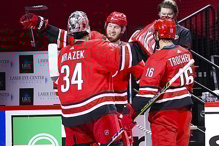 Apr 4, 2021; Raleigh, North Carolina, USA;  Carolina Hurricanes goaltender Petr Mrazek (34) and defenseman Jaccob Slavin (74) and center Vincent Trocheck (16) celebrate the win against the Dallas Stars at PNC Arena. Mandatory Credit: James Guillory-USA TODAY Sports