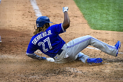 Apr 5, 2021; Arlington, Texas, USA; Toronto Blue Jays designated hitter Vladimir Guerrero Jr. (27) slides safely into home during the game between the Texas Rangers and the Toronto Blue Jays at Globe Life Field. Mandatory Credit: Jerome Miron-USA TODAY Sports