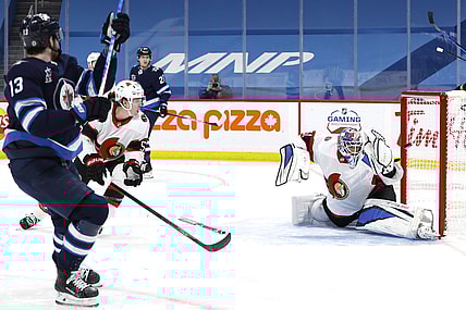 Apr 5, 2021; Winnipeg, Manitoba, CAN;  Winnipeg Jets left wing Pierre-Luc Dubois (13) scores on Ottawa Senators goaltender Anton Forsberg (31) in the second period at Bell MTS Place. Mandatory Credit: James Carey Lauder-USA TODAY Sports