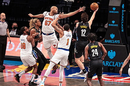 Apr 5, 2021; Brooklyn, New York, USA; Brooklyn Nets forward Joe Harris (12) shoots the ball against New York Knicks center Taj Gibson (67) and forward Obi Toppin (1) during the second half at Barclays Center. Mandatory Credit: Vincent Carchietta-USA TODAY Sports