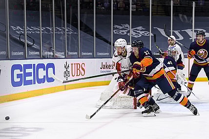 Apr 6, 2021; Uniondale, New York, USA;  New York Islanders center Mathew Barzal (13) and Washington Capitals right wing Tom Wilson (43) battle for the puck during the first period between the New York Islanders and the Washington Capitals at Nassau Veterans Memorial Coliseum. Mandatory Credit: Dennis Schneidler-USA TODAY Sports