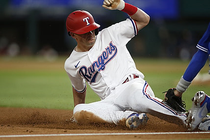 Apr 6, 2021; Arlington, Texas, USA; Texas Rangers second baseman Nick Solak (15) steals third base against Toronto Blue Jays third baseman Cavan Biggio (8) in the third inning at Globe Life Field. Mandatory Credit: Tim Heitman-USA TODAY Sports