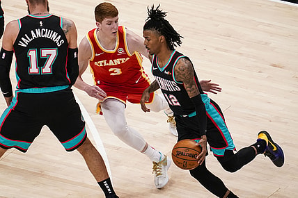 Apr 7, 2021; Atlanta, Georgia, USA; Memphis Grizzlies guard Ja Morant (12) tries to dribble past Atlanta Hawks guard Kevin Huerter (3) during the first quarter at State Farm Arena. Mandatory Credit: Dale Zanine-USA TODAY Sports