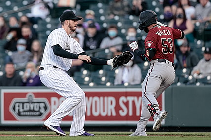 Apr 7, 2021; Denver, Colorado, USA; Colorado Rockies first baseman C.J. Cron (25) tags out Arizona Diamondbacks first baseman Christian Walker (53) in the first inning at Coors Field. Mandatory Credit: Isaiah J. Downing-USA TODAY Sports