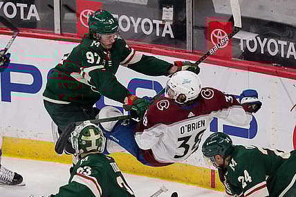 Apr 7, 2021; Saint Paul, Minnesota, USA;  Minnesota Wild forward Kirill Kaprizov (97) cross checks Colorado Avalanche forward Liam O'Brien (38) in the third period at Xcel Energy Center. Mandatory Credit: Brad Rempel-USA TODAY Sports
