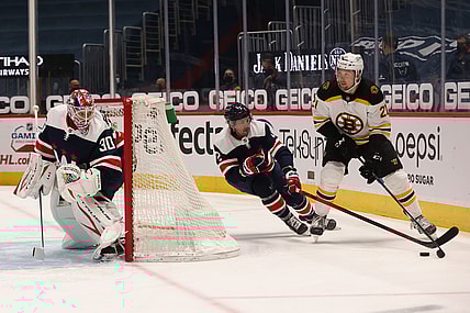 Apr 8, 2021; Washington, District of Columbia, USA; Boston Bruins left wing Nick Ritchie (21) skates with the puck behind Washington Capitals goaltender Ilya Samsonov (30) as Capitals defenseman Justin Schultz (2) defends in the first period at Capital One Arena. Mandatory Credit: Geoff Burke-USA TODAY Sports