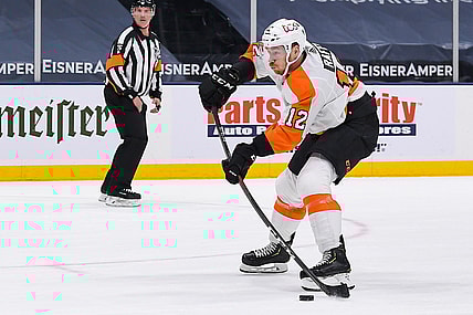 Apr 8, 2021; Uniondale, New York, USA; Philadelphia Flyers left wing Michael Raffl (12) shoots against the New York Islanders during the first period at Nassau Veterans Memorial Coliseum. Mandatory Credit: Dennis Schneidler-USA TODAY Sports