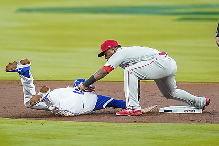 Apr 9, 2021; Cumberland, Georgia, USA; Atlanta Braves first baseman Freddie Freeman (5) is picked off of second base tagged out by  Philadelphia Phillies shortstop Jean Segura (2) during the first inning at Truist Park. Mandatory Credit: Dale Zanine-USA TODAY Sports