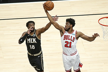 Apr 9, 2021; Atlanta, Georgia, USA; Chicago Bulls forward Thaddeus Young (21) grabs a rebound past Atlanta Hawks forward Solomon Hill (18) in the first quarter at State Farm Arena. Mandatory Credit: Brett Davis-USA TODAY Sports
