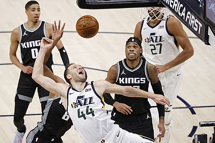 Apr 10, 2021; Salt Lake City, Utah, USA; Utah Jazz forward Bojan Bogdanovic (44) drives against Sacramento Kings forward Maurice Harkless (8) and center Richaun Holmes (22) in the second quarter at Vivint Smart Home Arena. Mandatory Credit: Jeffrey Swinger-USA TODAY Sports