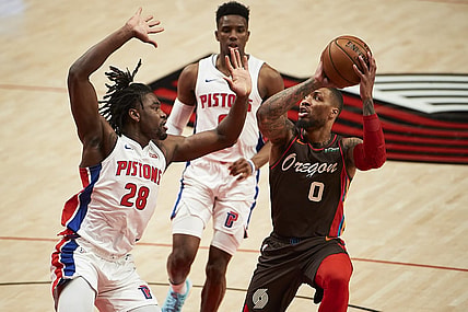 Apr 10, 2021; Portland, Oregon, USA; Portland Trail Blazers guard Damian Lillard (0) controls the ball against Detroit Pistons center Isaiah Stewart (28) during the first half at Moda Center. Mandatory Credit: Troy Wayrynen-USA TODAY Sports