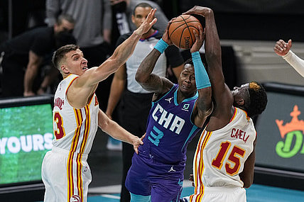 Apr 11, 2021; Charlotte, North Carolina, USA; Charlotte Hornets guard Terry Rozier (3) gets fouled going up for a shot defended by Atlanta Hawks center Clint Capela (15) and guard Bogdan Bogdanovic (13) during the second quarter at Spectrum Center. Mandatory Credit: Jim Dedmon-USA TODAY Sports