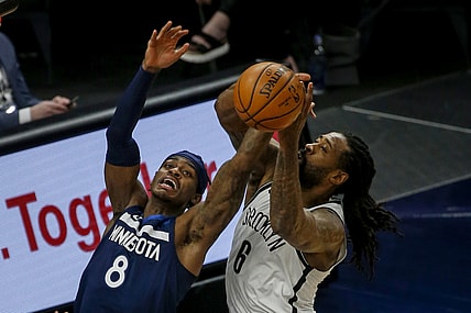 Apr 13, 2021; Minneapolis, Minnesota, USA; Minnesota Timberwolves forward Jarred Vanderbilt (8) competes with Brooklyn Nets forward Joe Harris (12) for the ball in the first half at Target Center. Mandatory Credit: Bruce Kluckhohn-USA TODAY Sports