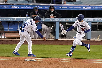 Apr 13, 2021; Los Angeles, California, USA; Los Angeles Dodgers right fielder Mookie Betts (50) is congratulated by first base coach Clayton McCullough (L) after hitting a home run during the third inning against the Colorado Rockies at Dodger Stadium. Mandatory Credit: Kirby Lee-USA TODAY Sports