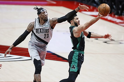Apr 13, 2021; Portland, Oregon, USA; Boston Celtics small forward Jayson Tatum (right) shoots the ball against Portland Trail Blazers power forward Robert Covington (23) during the second half at Moda Center. Mandatory Credit: Soobum Im-USA TODAY Sports