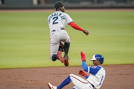 Apr 14, 2021; Cumberland, Georgia, USA; Miami Marlins second baseman Jazz Chisholm Jr. (2) jumps over Atlanta Braves second baseman Ozzie Albies (1) as he throws to first base to complete a double play during the second inning at Truist Park. Mandatory Credit: Dale Zanine-USA TODAY Sports