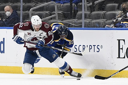 Apr 14, 2021; St. Louis, Missouri, USA; Colorado Avalanche left wing Gabriel Landeskog (92) checks St. Louis Blues left wing David Perron (57) during the first period at Enterprise Center. Mandatory Credit: Jeff Le-USA TODAY Sports