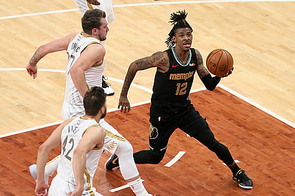 Apr 14, 2021; Memphis, Tennessee, USA; Memphis Grizzlies guard Ja Morant (12) drives to the basket as  Dallas Mavericks guard Luka Doncic (77) defends during the second quarter at FedExForum. Mandatory Credit: Nelson Chenault-USA TODAY Sports