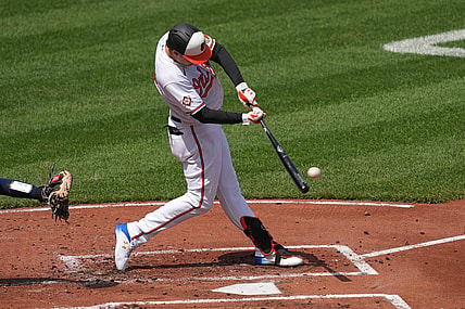 Apr 15, 2021; Baltimore, Maryland, USA; Baltimore Orioles outfielder Ryan Mountcastle (42) connects on a single in the first inning against the Seattle Mariners at Oriole Park at Camden Yards. Mandatory Credit: Mitch Stringer-USA TODAY Sports