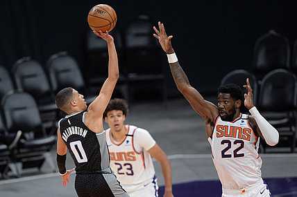 Apr 15, 2021; Phoenix, Arizona, USA; Sacramento Kings guard Tyrese Haliburton (0) shoots over Phoenix Suns center Deandre Ayton (22) during the second half at Phoenix Suns Arena. Mandatory Credit: Joe Camporeale-USA TODAY Sports