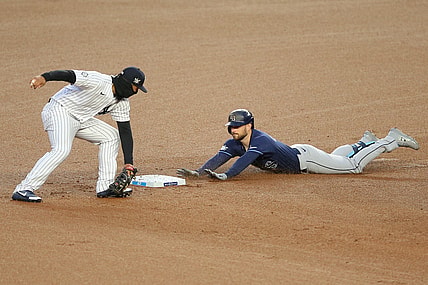 Apr 16, 2021; Bronx, New York, USA; Tampa Bay Rays second baseman Brandon Lowe slides safely into second with a two-run double ahead of the tag by New York Yankees shortstop Gleyber Torres during the first inning at Yankee Stadium. Mandatory Credit: Brad Penner-USA TODAY Sports