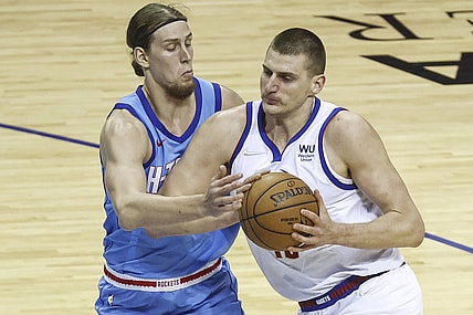Apr 16, 2021; Houston, Texas, USA; Denver Nuggets center Nikola Jokic (15) drives with the ball as Houston Rockets forward Kelly Olynyk (41) defends during the first quarter at Toyota Center. Mandatory Credit: Troy Taormina-USA TODAY Sports