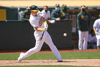 Apr 17, 2021; Oakland, California, USA;  Oakland Athletics third baseman Matt Chapman (26) hits a RBI single during the fifth inning against the Detroit Tigers at RingCentral Coliseum. Mandatory Credit: Stan Szeto-USA TODAY Sports