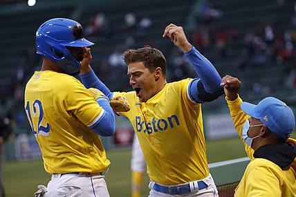 Apr 17, 2021; Boston, Massachusetts, USA; Boston Red Sox third baseman Marwin Gonzalez (12) is greeted by second baseman Enrique Hernandez (5) (center) after his home run against the Chicago White Sox as manager Alex Cora (20) looks on during the eighth inning at Fenway Park. Mandatory Credit: Winslow Townson-USA TODAY Sports