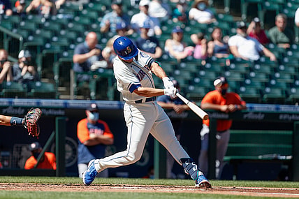 Apr 18, 2021; Seattle, Washington, USA; Seattle Mariners first baseman Evan White (12) hits an RBI single against the Houston Astros during the first inning at T-Mobile Park. Mandatory Credit: Jennifer Buchanan-USA TODAY Sports