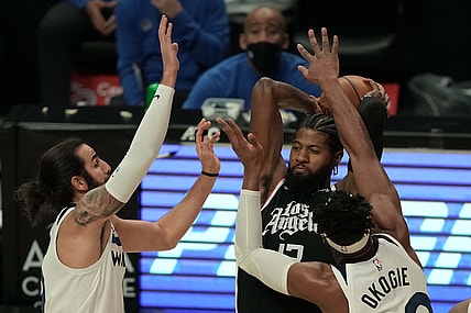 Apr 18, 2021; Los Angeles, California, USA; LA Clippers guard Paul George (13) is defended by Minnesota Timberwolves center Naz Reid (11) and forward Josh Okogie (20) in the first half at Staples Center. Mandatory Credit: Kirby Lee-USA TODAY Sports