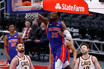 Apr 19, 2021; Detroit, Michigan, USA;  Detroit Pistons forward Tyler Cook (25) dunks on Cleveland Cavaliers forward Kevin Love (0) and guard Matthew Dellavedova (18) in the first half at Little Caesars Arena. Mandatory Credit: Rick Osentoski-USA TODAY Sports